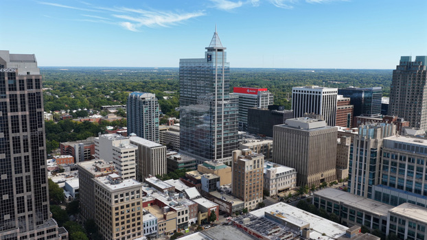 Aerial view of the Raleigh skyline featuring the PNC Plaza skyscraper modern office buildings and dense urban architecture in Raleigh North Carolina United States. Aerial view of the Raleigh skyline featuring the PNC Plaza skyscraper modern office buildings and dense urban architecture in Raleigh North Carolina United States.