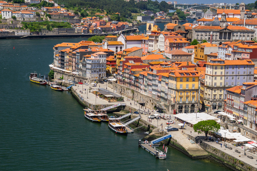 Aerial view of the vibrant Ribeira district s terracotta roofs cascading down to the Douro River where boats bob gently in the deep blue water Porto Porto District Portugal. Aerial view of the vibrant Ribeira district s terracotta roofs cascading down to the Douro River where boats bob gently in the deep blue water Porto Porto District Portugal.