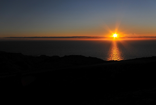 View of the golden sunset over the Atlantic Ocean at Puerto Piramides with dark coastal silhouettes Puerto Madryn Chubut Argentina. View of the golden sunset over the Atlantic Ocean at Puerto Piramides with dark coastal silhouettes Puerto Madryn Chubut Argentina.