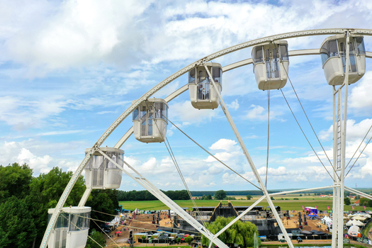 Herzogenaurach Germany 27 July 2025 Aerial view of the Open Beatz Festival with a white Ferris wheel in the foreground overlooking stages and green fields. Herzogenaurach Germany 27 July 2025 Aerial view of the Open Beatz Festival with a white Ferris wheel in the foreground overlooking stages and green fields.