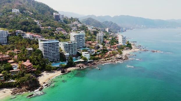 Aerial view of coastal condos and mountains Mexico.