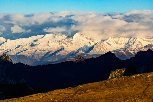 Aerial view of snow capped peaks pierce the sky casting long shadows over the rugged terrain a symphony of light and shadow Veneto Italy. Aerial view of snow capped peaks pierce the sky casting long shadows over the rugged terrain a symphony of light and shadow Veneto Italy.