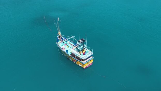 Aerial view of a traditional fishing boat on turquoise sea Maldives. Aerial view of a traditional fishing boat on turquoise sea Maldives.