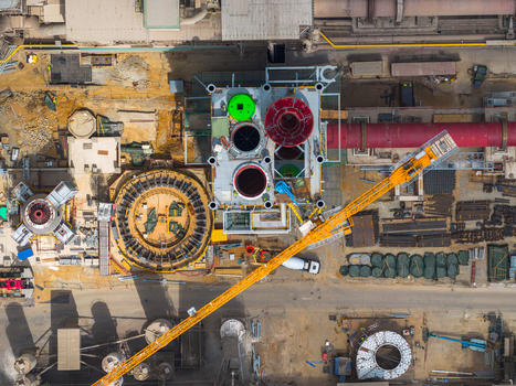 Aerial view of an industrial facility with a large yellow crane complex machinery and workers at a cement plant in Mokra Horakov Jihomoravsky kraj Czechia. Aerial view of an industrial facility with a large yellow crane complex machinery and workers at a cement plant in Mokra Horakov Jihomoravsky kraj Czechia.
