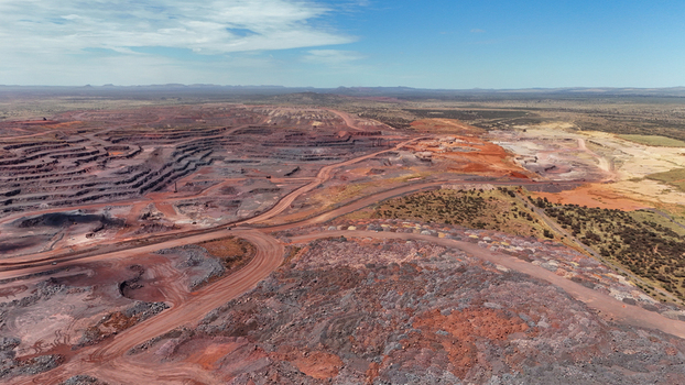 Aerial view of a sprawling open pit mine showcasing the vibrant red earth and stark grey rock of its terraced depths Rustenburg North West South Africa. Aerial view of a sprawling open pit mine showcasing the vibrant red earth and stark grey rock of its terraced depths Rustenburg North West South Africa.