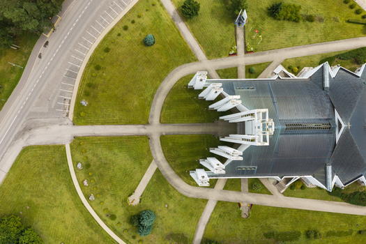 Aerial view of the Church of the Assumption of the Virgin Mary with its distinctive modern architecture surrounding green lawns and paved walkways in Elektrenai Vilnius County Lithuania. Aerial view of the Church of the Assumption of the Virgin Mary with its distinctive modern architecture surrounding green lawns and paved walkways in Elektrenai Vilnius County Lithuania.