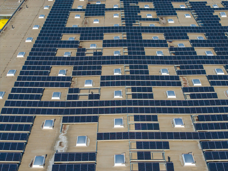 Aerial view of Logistikzentrum Allhaming featuring extensive solar panel arrays and numerous skylights on the industrial roof in Allhaming Oberosterreich Austria. Aerial view of Logistikzentrum Allhaming featuring extensive solar panel arrays and numerous skylights on the industrial roof in Allhaming Oberosterreich Austria.