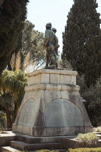 View of a stone monument stands amidst lush greenery its weathered inscriptions telling tales of the past in the Sicilian sun Taormina Sicily Italy.