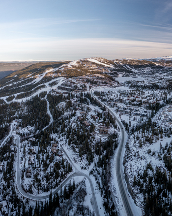 Aerial view of Gaustablikk Fjellresort surrounded by snowy mountains winding roads and pine forests in Rjukan Telemark Norway. Aerial view of Gaustablikk Fjellresort surrounded by snowy mountains winding roads and pine forests in Rjukan Telemark Norway.