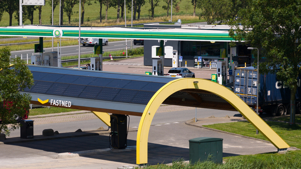 Middenbeemster Noord Holland Netherlands 20 June 2026 Aerial view of Fastned charging station with solar panels electric vehicle chargers and a nearby gas station.
