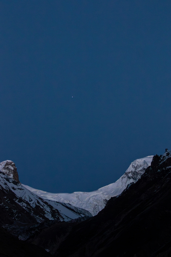 View of the snow covered peaks of K2 Base Camp under a deep blue twilight sky in Ghakhar Gilgit Pakistan. View of the snow covered peaks of K2 Base Camp under a deep blue twilight sky in Ghakhar Gilgit Pakistan.