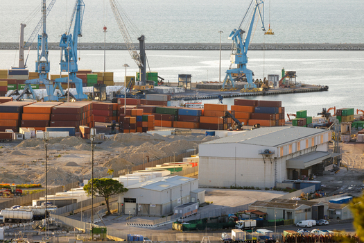 Aerial view of Ancona Port with colorful shipping containers large industrial cranes and warehouse facilities under clear daylight in Ancona Marche Italy. Aerial view of Ancona Port with colorful shipping containers large industrial cranes and warehouse facilities under clear daylight in Ancona Marche Italy.