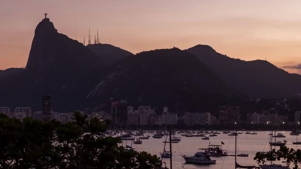 View of Botafogo Bay at sunset with boats and Christ the Redeemer Brazil.