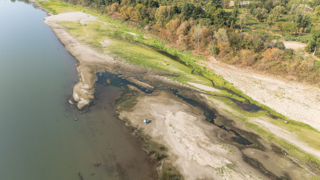 Aerial view of the Po River with low water levels from drought exposing sandy riverbeds and dry beaches near Castelvetro Piacentino Emilia Romagna Italy. Aerial view of the Po River with low water levels from drought exposing sandy riverbeds and dry beaches near Castelvetro Piacentino Emilia Romagna Italy.