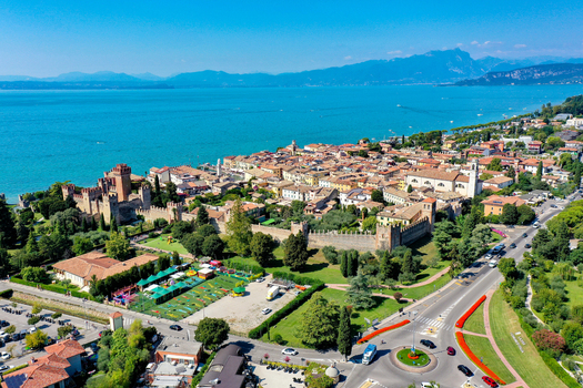 Aerial view of the historic town of Lazise and Scaligero Castle on the shores of Lake Garda with medieval walls and colorful buildings in Provincia di Verona Veneto Italy.