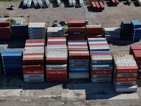 Cincinnati United States 19 April 2026 Aerial view of stacks of colorful shipping containers in an industrial yard with logistics trailers in the background.