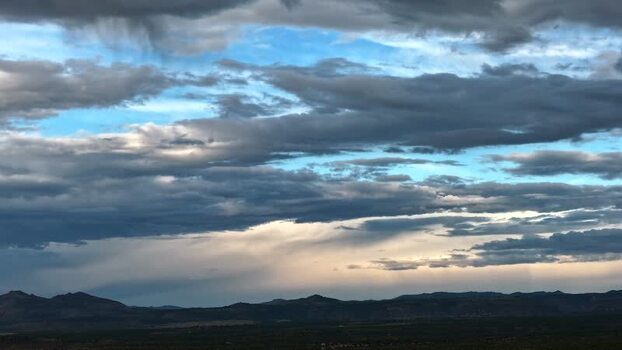 Aerial view of shifting clouds over mountains United States.