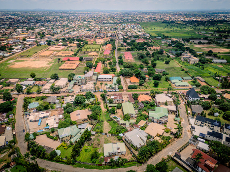 Aerial view of the Barnawa neighborhood featuring residential houses lush green trees and paved roads in Kaduna Kaduna Nigeria. Aerial view of the Barnawa neighborhood featuring residential houses lush green trees and paved roads in Kaduna Kaduna Nigeria.