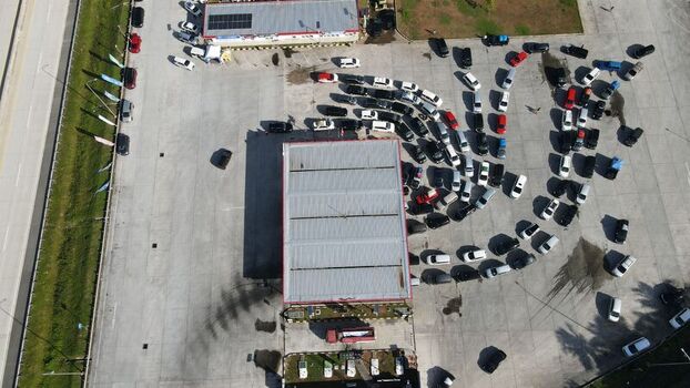 Aerial view of Jalan Tol Terbanggi Besar Pematang Panggang Kayu Agung rest area with cars parked in rows on the concrete lot in Kecamatan Lempuing Jaya Sumatera Selatan Indonesia. Aerial view of Jalan Tol Terbanggi Besar Pematang Panggang Kayu Agung rest area with cars parked in rows on the concrete lot in Kecamatan Lempuing Jaya Sumatera Selatan Indonesia.