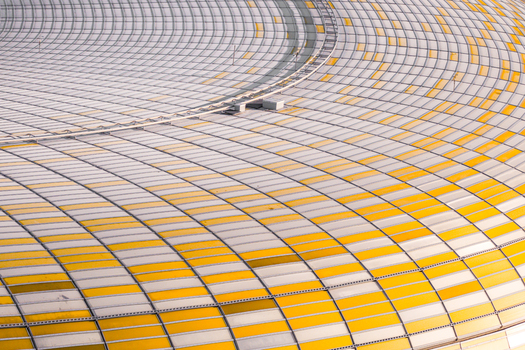 Aerial view of the stadium roof showcases a symphony of yellow and white panels creating a mesmerizing geometric pattern Gdansk Pomeranian Voivodeship Poland. Aerial view of the stadium roof showcases a symphony of yellow and white panels creating a mesmerizing geometric pattern Gdansk Pomeranian Voivodeship Poland.