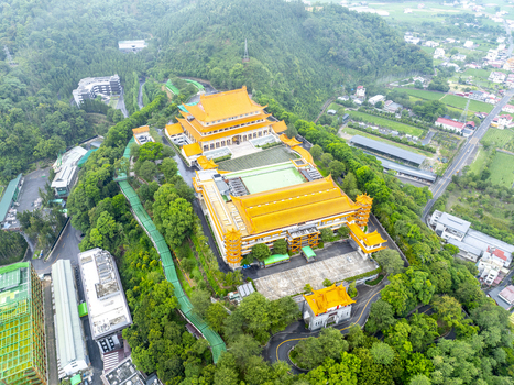 Aerial view of the Chung Tai Chan Monastery featuring its distinctive golden roofs expansive courtyards and lush green forested surroundings in Puli Township Nantou County Taiwan. Aerial view of the Chung Tai Chan Monastery featuring its distinctive golden roofs expansive courtyards and lush green forested surroundings in Puli Township Nantou County Taiwan.