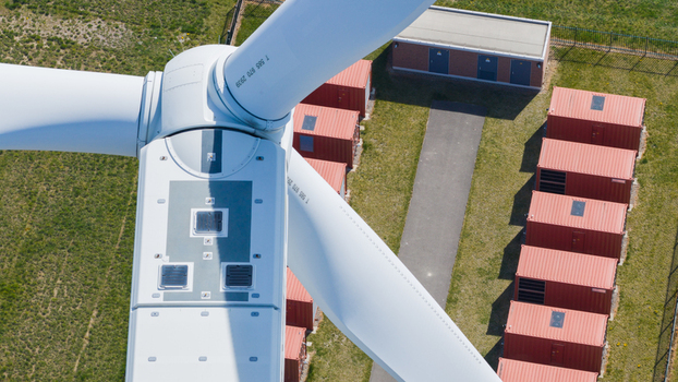 Aerial view of battery storage system at wind park with wind turbines