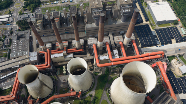 Aerial view of Kraftwerk Niederaussem with its large cooling towers tall chimneys and complex network of industrial pipes in Bergheim Nordrhein Westfalen Germany. Aerial view of Kraftwerk Niederaussem with its large cooling towers tall chimneys and complex network of industrial pipes in Bergheim Nordrhein Westfalen Germany.