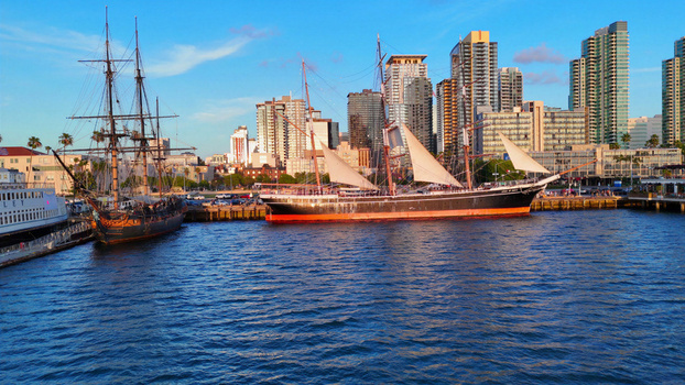 San Diego California United States 01 April 2026 Aerial view of the historic Star of India tall ship and another vessel docked at the North Embarcadero with the city skyline in the background.