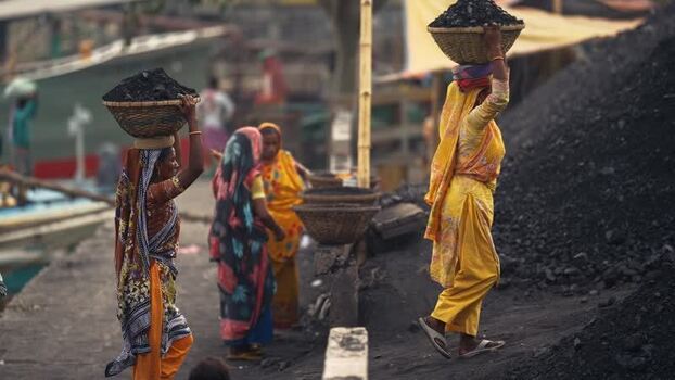 View of women carrying coal baskets in Aminbazar Bangladesh. View of women carrying coal baskets in Aminbazar Bangladesh.