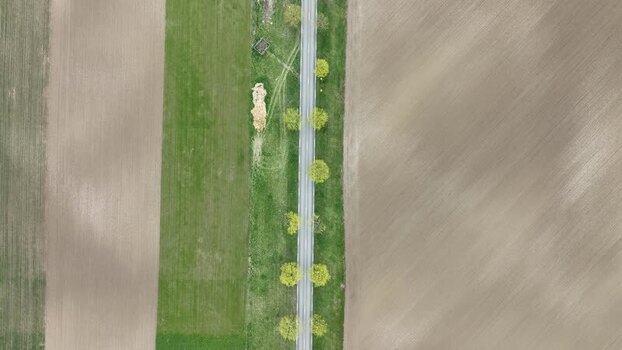 Aerial view of fields and a road with a car France.