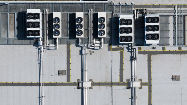 Aerial view of industrial HVAC units with large fans and complex piping on a flat rooftop in Utrecht Utrecht Netherlands. Aerial view of industrial HVAC units with large fans and complex piping on a flat rooftop in Utrecht Utrecht Netherlands.