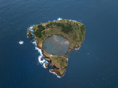 Aerial view of Ilheu de Vila Franca do Campo a volcanic islet with a central circular lagoon surrounded by the Atlantic Ocean featuring rocky cliffs Sao Pedro Acores Portugal. Aerial view of Ilheu de Vila Franca do Campo a volcanic islet with a central circular lagoon surrounded by the Atlantic Ocean featuring rocky cliffs Sao Pedro Acores Portugal.