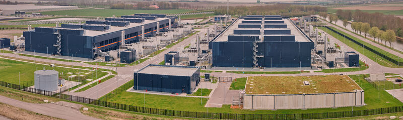 Middenmeer Netherlands 14 May 2026 Aerial view of Microsoft Datacenter Campus AMS 13 14 featuring large industrial buildings with dark facades and cooling infrastructure. Middenmeer Netherlands 14 May 2026 Aerial view of Microsoft Datacenter Campus AMS 13 14 featuring large industrial buildings with dark facades and cooling infrastructure.