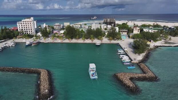 Aerial view of the harbor and coastal buildings in Gulhi Maldives. Aerial view of the harbor and coastal buildings in Gulhi Maldives.