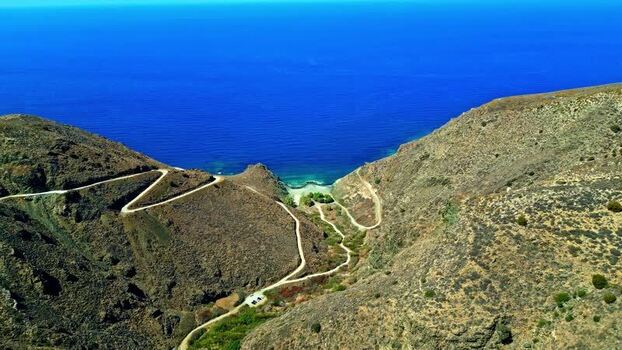 Aerial view of winding road to a beach in Crete Greece.