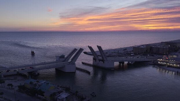Aerial view of John s Pass Bridge opening at sunset United States. Aerial view of John s Pass Bridge opening at sunset United States.