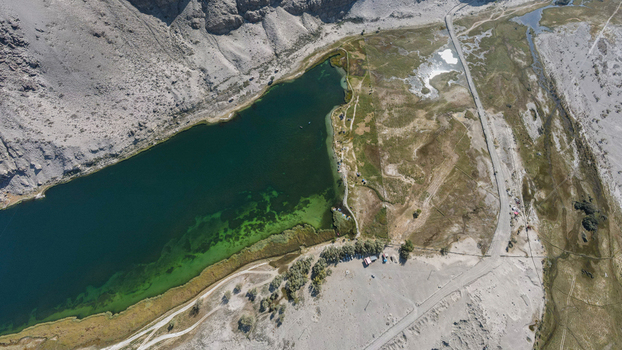 Aerial view of Blind Lake Sarfaranga Shigar surrounded by arid mountain terrain desert landscape and sparse vegetation in Skardu Gilgit Pakistan.