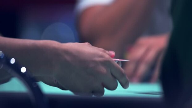 View of hands holding playing cards at a poker table Portugal. View of hands holding playing cards at a poker table Portugal.