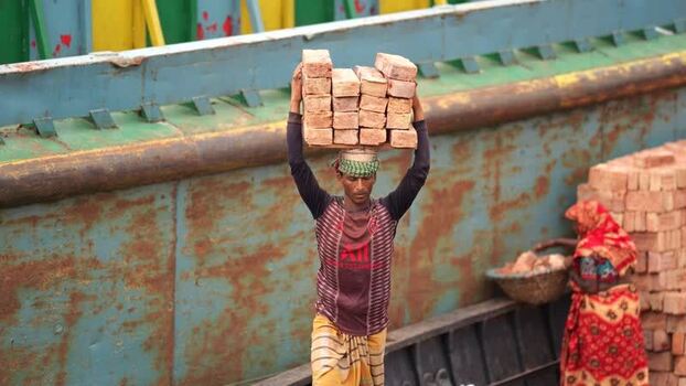 View of a worker carrying bricks at Aminbazar Bangladesh. View of a worker carrying bricks at Aminbazar Bangladesh.