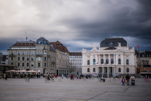 Zurich Switzerland 02 April 2023 View of the grand architecture of the Opernhaus Zürich under a dramatic moody sky its white facade a stark contrast to the approaching storm clouds. Zurich Switzerland 02 April 2023 View of the grand architecture of the Opernhaus Zürich under a dramatic moody sky its white facade a stark contrast to the approaching storm clouds.