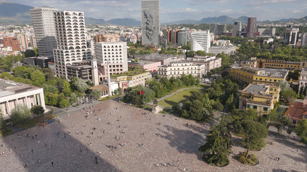 Aerial view of Skanderbeg Square featuring modern skyscrapers historic buildings the Et hem Bey Mosque and people walking across the plaza in Tirane Qarku i Tiranes Albania.