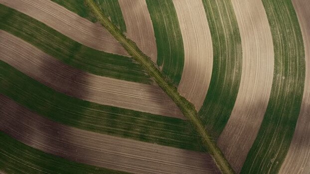 Aerial view of striped agricultural fields in Brno Czechia.