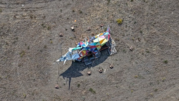 Aerial view of a colorful geometric art installation situated in a dry open field in Golden Colorado United States.