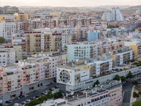 Aerial view of the dense urban landscape of Lisbon featuring modern apartment buildings residential blocks and streets in Lisbon Lisbon Portugal.