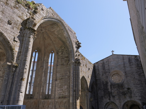 View of Ruinas de San Domingos showing Gothic stone arches weathered walls and a rose window under a clear blue sky in Pontevedra Pontevedra Spain. View of Ruinas de San Domingos showing Gothic stone arches weathered walls and a rose window under a clear blue sky in Pontevedra Pontevedra Spain.