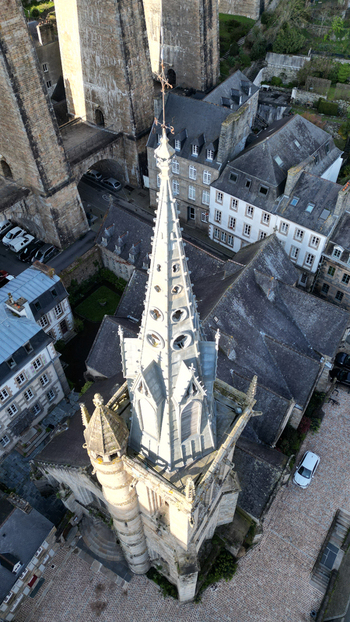 Aerial view of Eglise Saint Melaine de Morlaix featuring its ornate gothic spire historic stone houses and the massive viaduct in Morlaix Bretagne France. Aerial view of Eglise Saint Melaine de Morlaix featuring its ornate gothic spire historic stone houses and the massive viaduct in Morlaix Bretagne France.