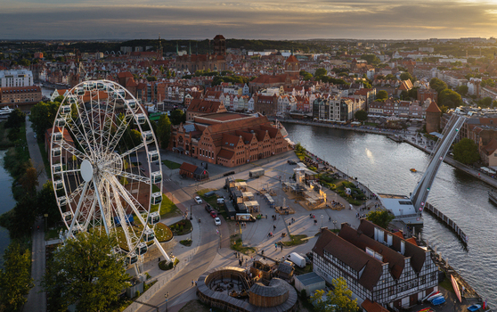 Aerial view of the Ferris wheel on Olowianka Island with the historic city skyline Motlawa River and the pedestrian drawbridge in Gdansk Pomeranian Voivodeship Poland. Aerial view of the Ferris wheel on Olowianka Island with the historic city skyline Motlawa River and the pedestrian drawbridge in Gdansk Pomeranian Voivodeship Poland.