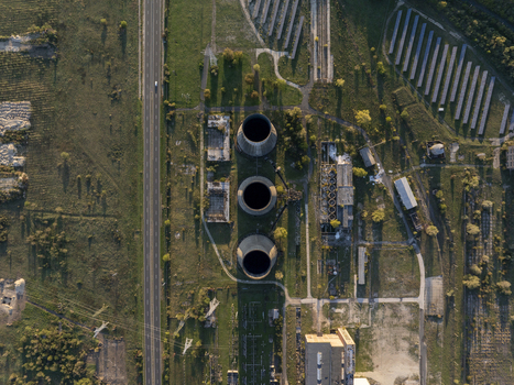 Aerial view of the abandoned Inota Power Plant cooling towers surrounded by industrial ruins and solar panels in Varpalota Hungary. Aerial view of the abandoned Inota Power Plant cooling towers surrounded by industrial ruins and solar panels in Varpalota Hungary.