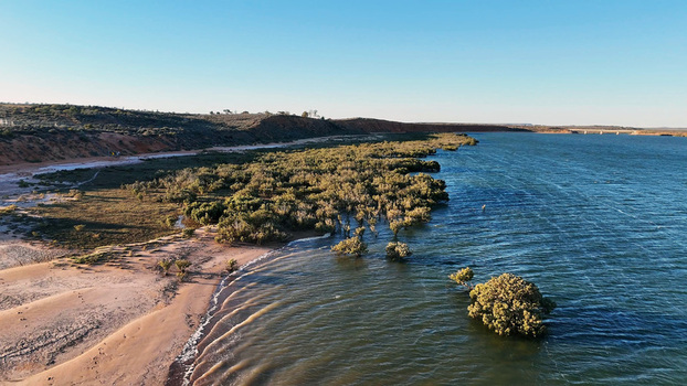 Aerial view of Matthew Flinders Red Cliff Lookout with red cliffs mangroves along the shoreline and calm waters Port Augusta West South Australia Australia. Aerial view of Matthew Flinders Red Cliff Lookout with red cliffs mangroves along the shoreline and calm waters Port Augusta West South Australia Australia.