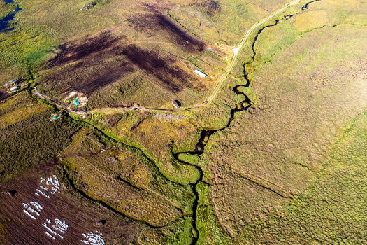 Aerial view of the rugged peat bog landscape and winding stream at An Port in Ardara County Donegal Ireland.